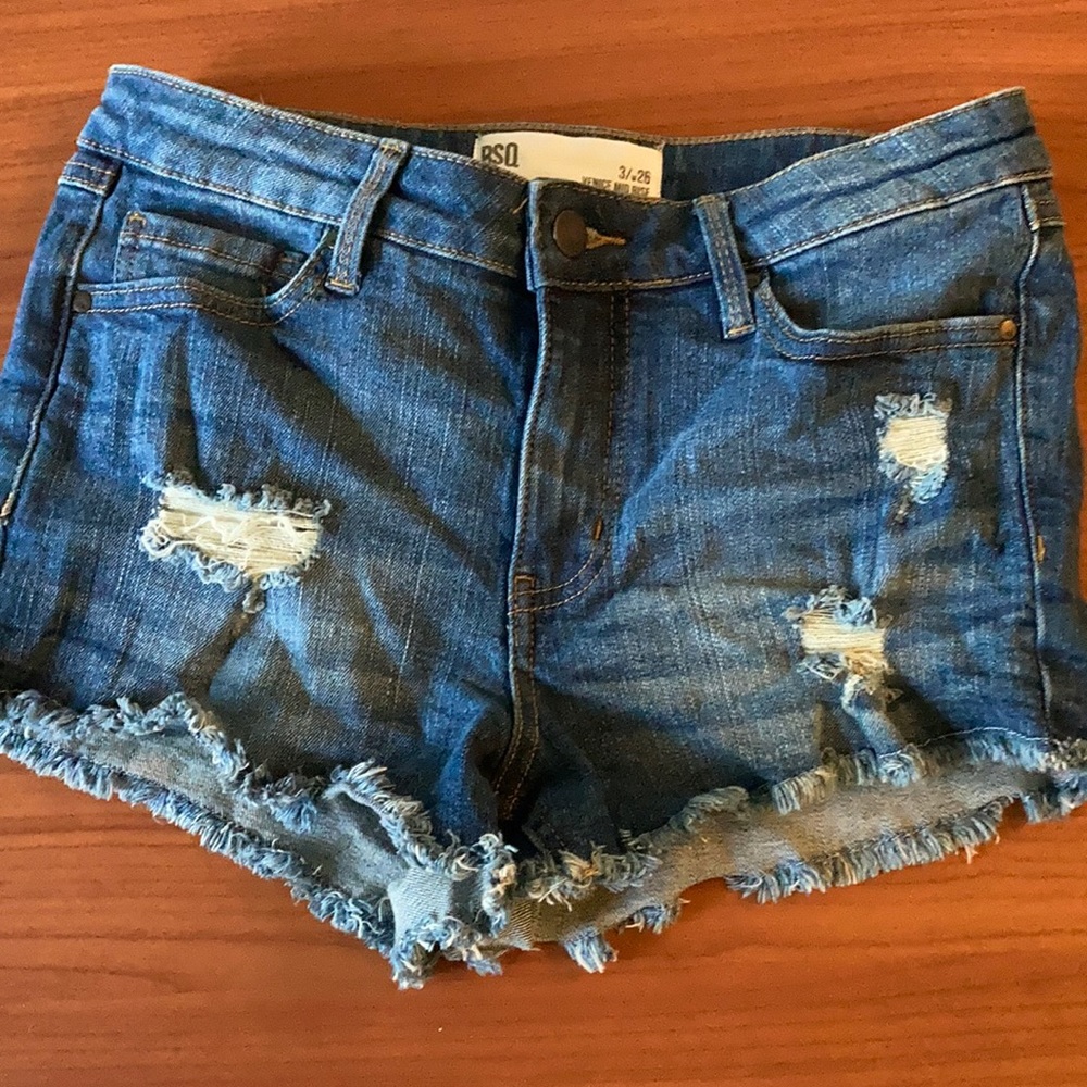 RSQ mid rise short shorts with fringe.
